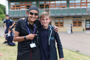 Principal Ms Gurjit Shergill is pictured with a young male student, smiling for the camera during a Sports Day at the academy.