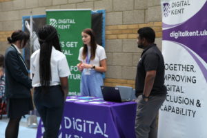 Two students are pictured conversing with two ambassadors from a company at a Meet The Employer event for Post-16 students.