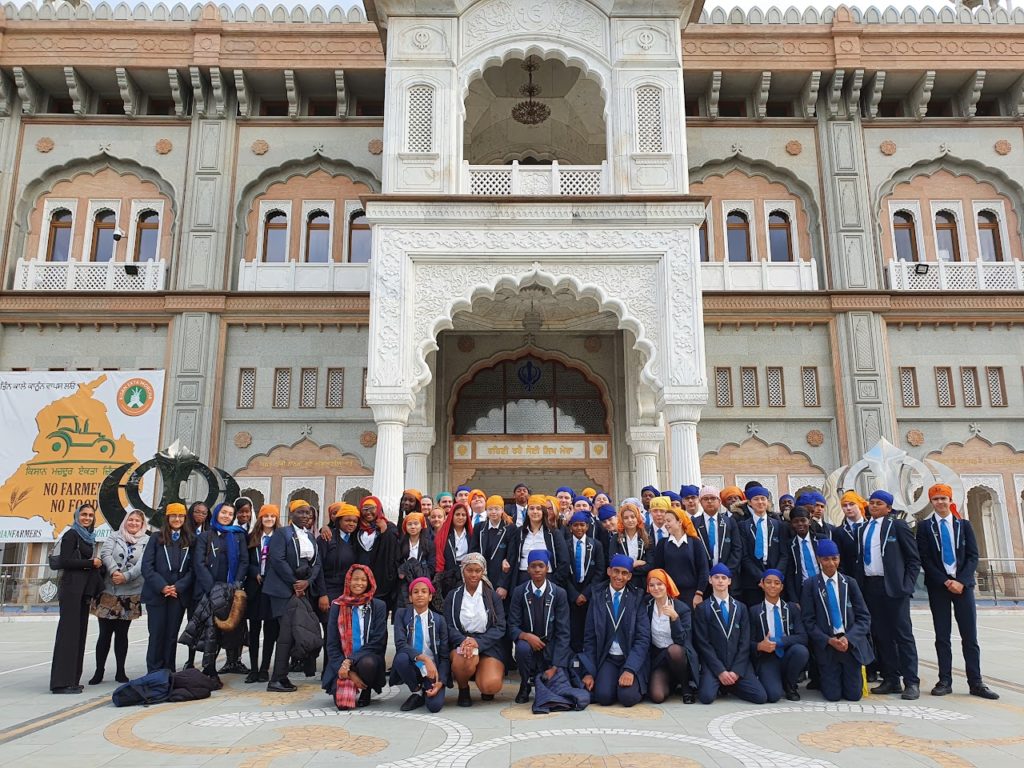 Year 10 students can be seen posing for the camera for a large group photo outside the Gurdwara in Gravesend during a school trip.