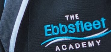 Close-up image of the embroidered logo for Ebbsfleet Academy on a PE Kit shirt.