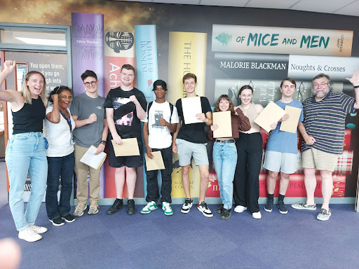 Group shot of students holding their results
