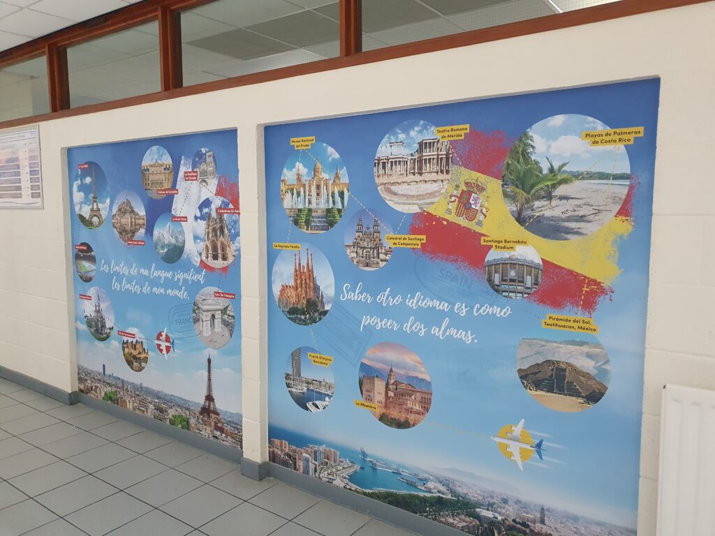 Photo showing a corridor inside the Ebbsfleet Academy building, featuring information and images of different landmarks around the world.