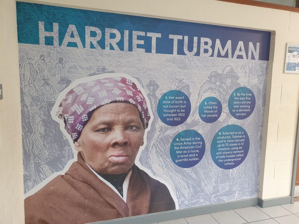 Photo showing a corridor inside the Ebbsfleet Academy building, featuring information and an image of American Social Activist, Harriet Tubman.
