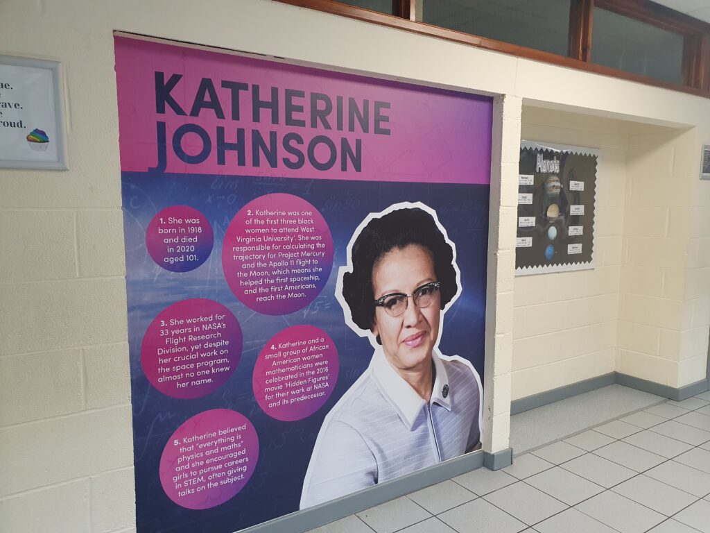 Photo showing a corridor inside the Ebbsfleet Academy building, featuring information and an image of American Mathematician, Katherine Johnson.