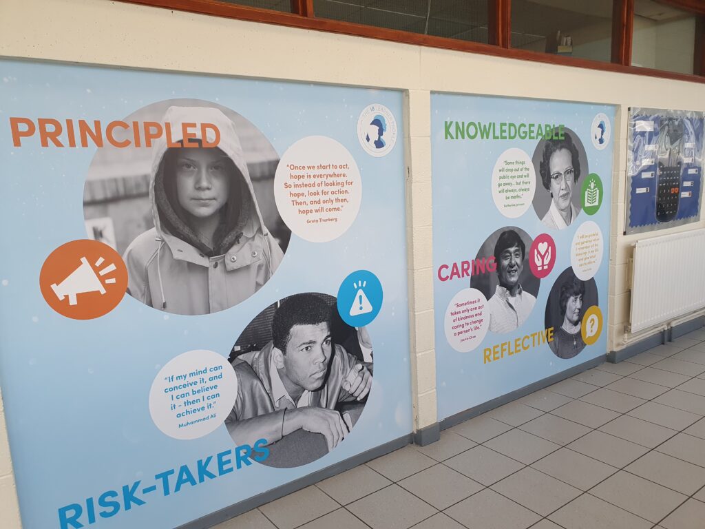 Photo showing a corridor inside the Ebbsfleet Academy building, featuring information and images of different notable people from history.