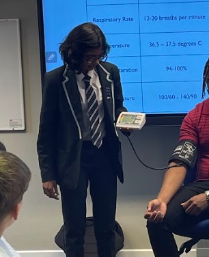 A Year 8 student using a blood pressure machine