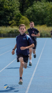 Male student running during a race at LAT Sports Day 2023