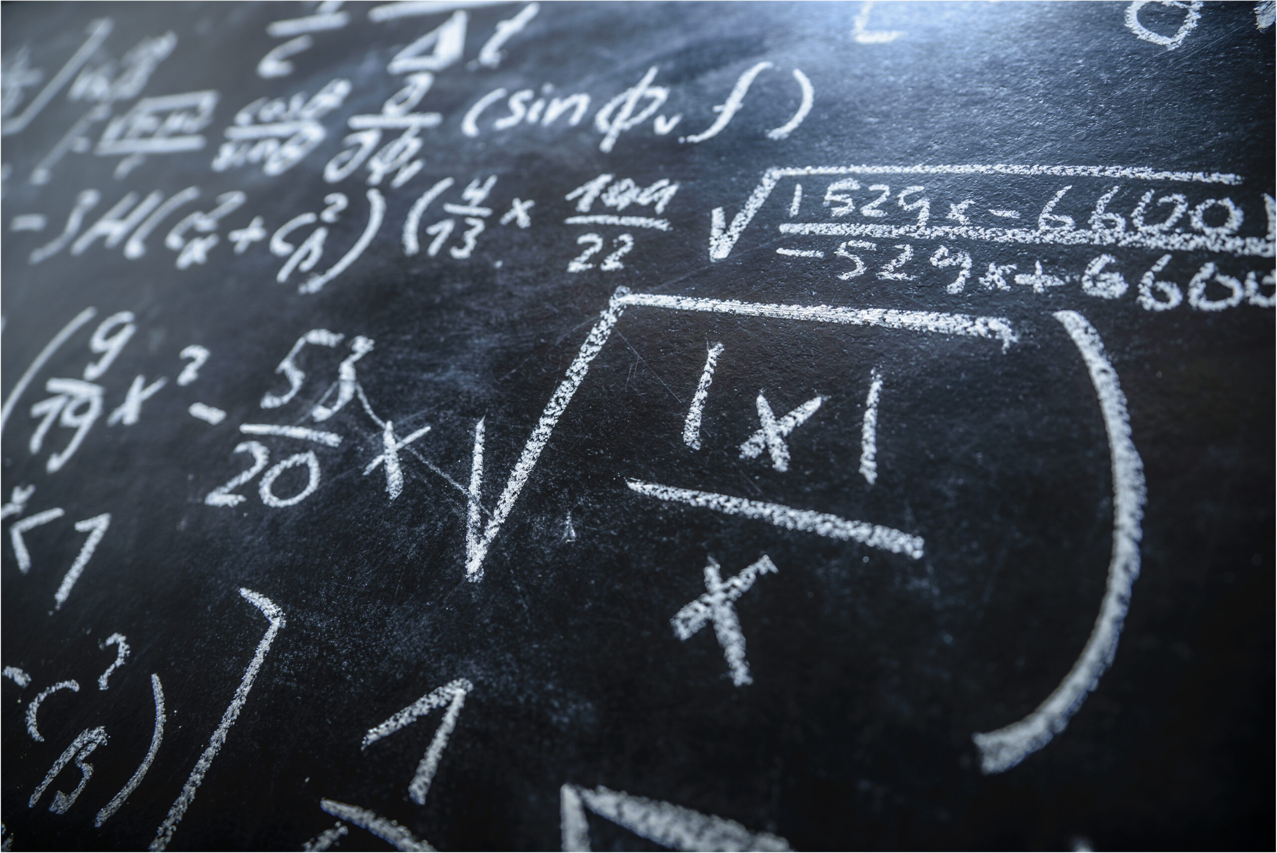 Mathematical equations seen drawn with chalk on a blackboard.