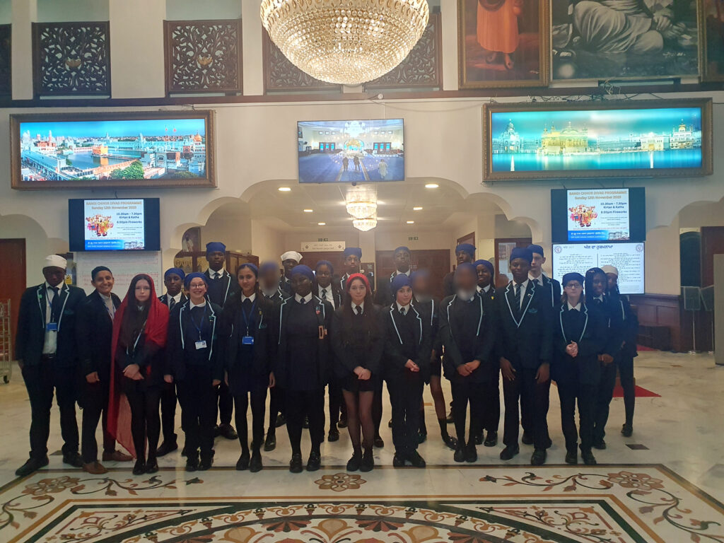 Students stood inside a Gurdwara during a school trip to learn about different religions.