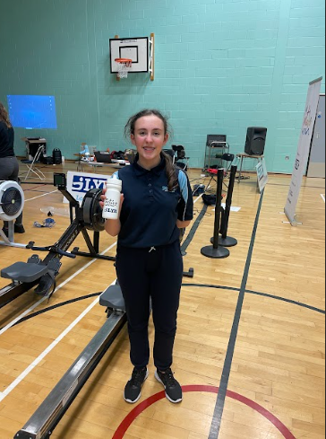 A female Ebbsfleet Academy student is seen smiling for the camera, whilst at Sir Joseph Williamson's Mathematical School for a Rowing Competition.