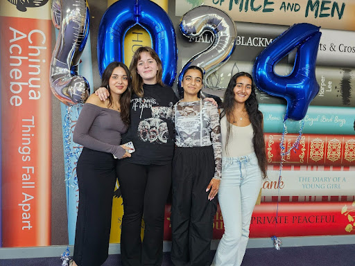 A group of four female Post-16 students are pictured smiling together for the camera, after having just received their A-Level results.