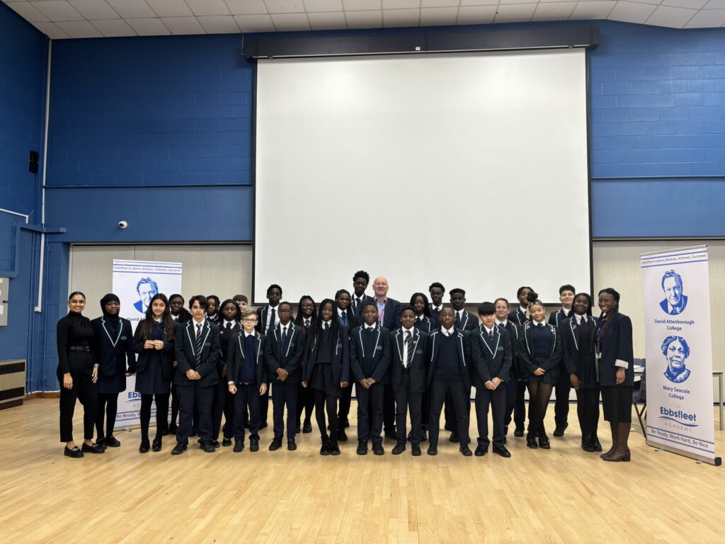 A group photo of Jim Dickson and a large group of students