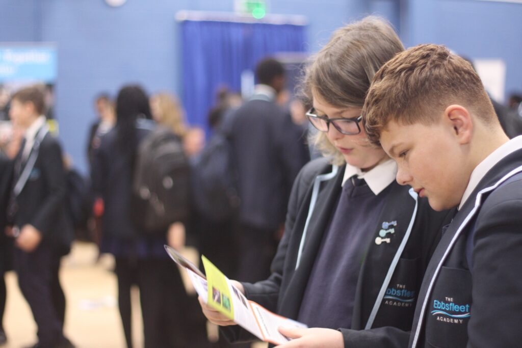 Two students looking at a leaflet