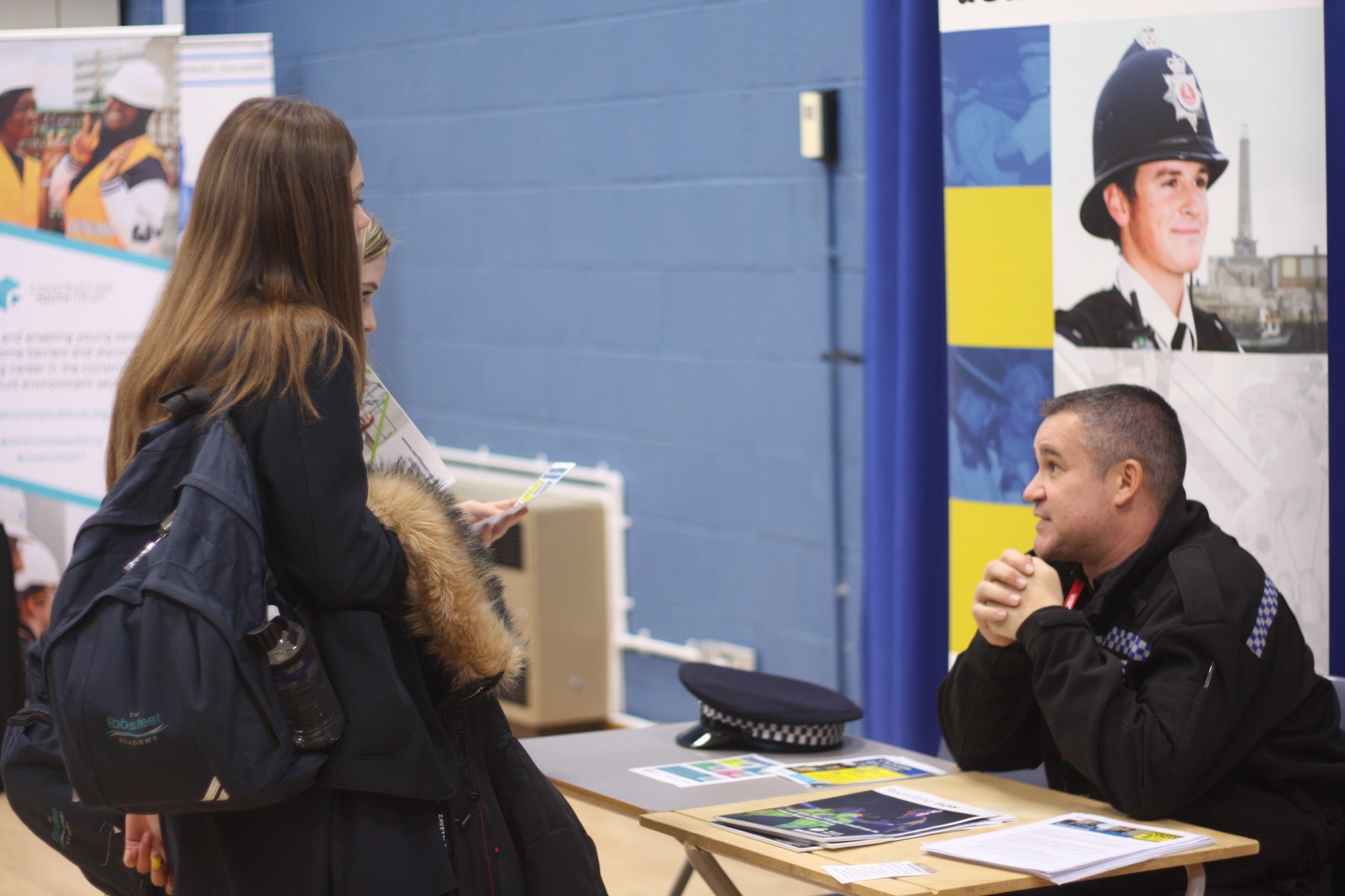 Two students talking to a police officer